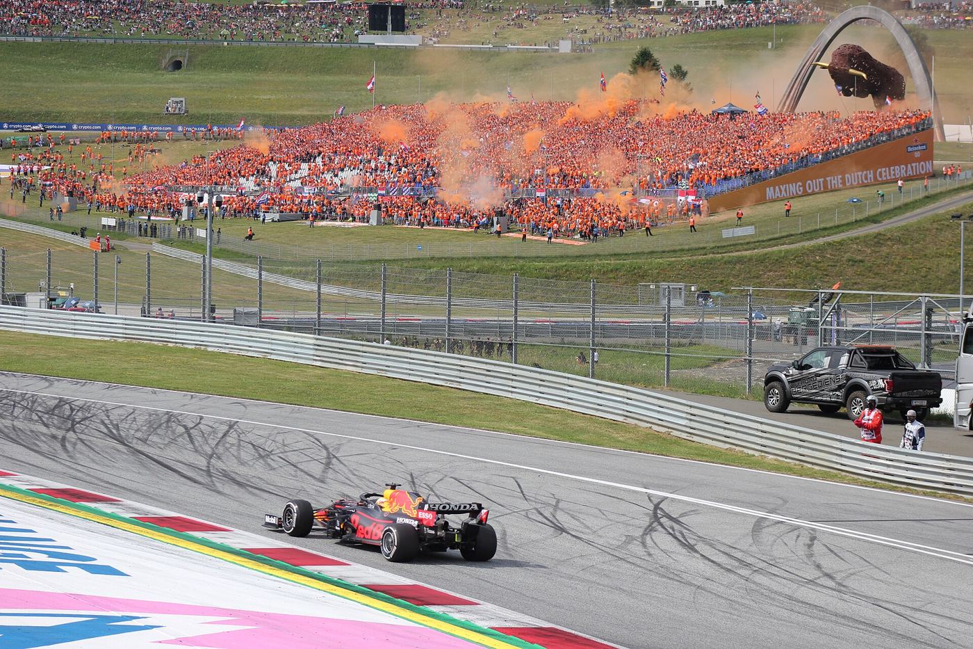 Max Verstappen in the foreground with celebrating Dutch fans behind him